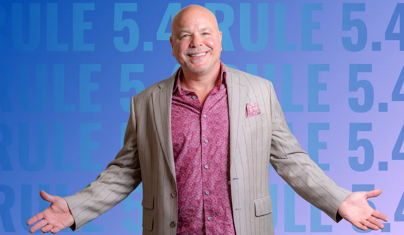 Smiling business coach with open arms in front of blue background displaying “Rule 5.4”